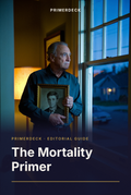 PrimerDeck cover: The Mortality Primer: older man stands by a window holding an old photo of himself, blue light